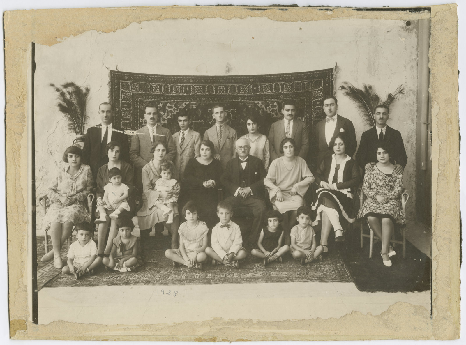 The annual family photo of the Spridon Sarouf family, Jaffa, 1928. From the family album of Abla and Alfred Tubasi. ©The Palestinian Museum.