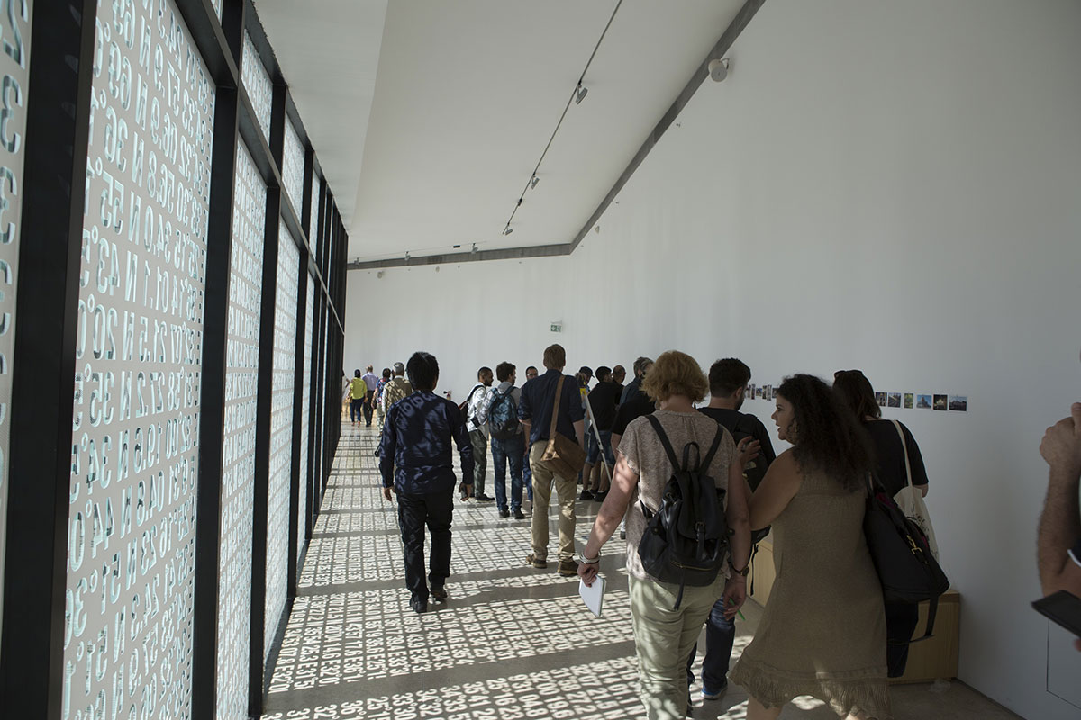 Mohamed Kazem, Directions (Border), 2017. Vinyl on glass, dimensions variable. Photo by Hamoudi Trad. © The Palestinian Museum.