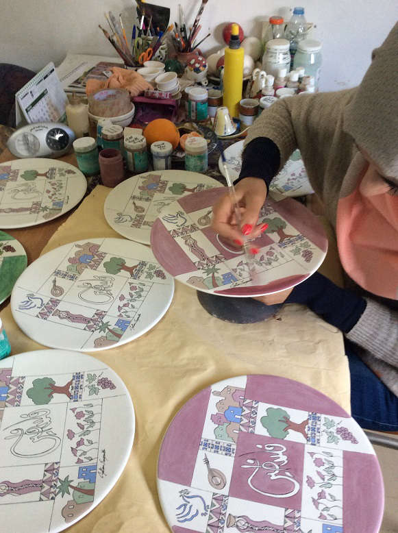 A craftswoman painting a ceramic plate at the Salsal workshop in Beit Sahour. Photo credit: UNIDO Palestine.